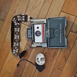 Vintage Polaroid automatic 104 land camera with beautiful strap